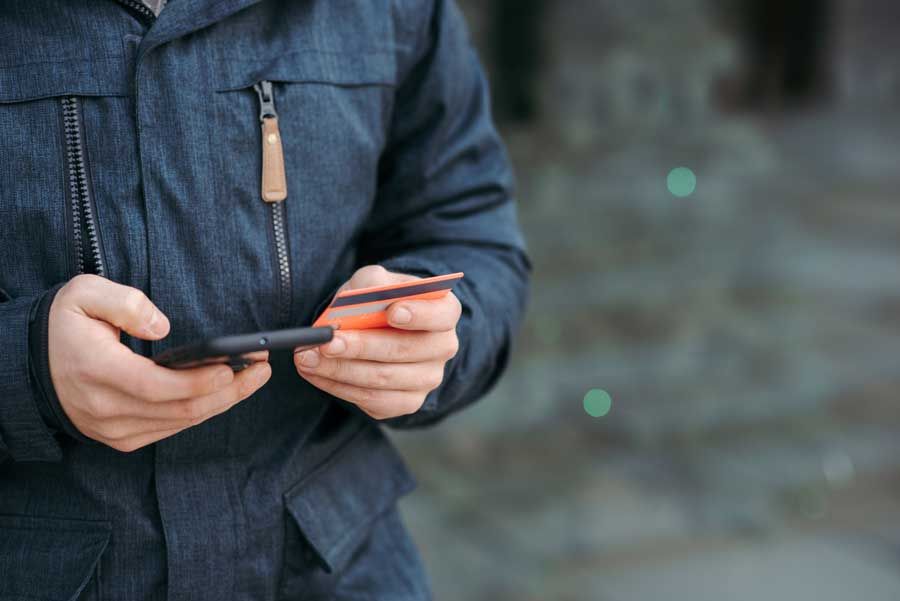 A fleet owner loads up fleet cards to a management mobile app.