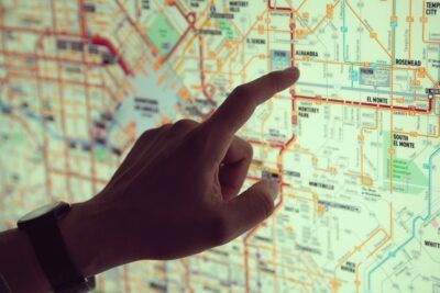 Finger pointing to city map showing routes