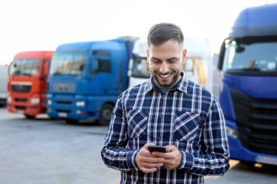 A truck driver tracks his gas station purchases on his fleet card app.