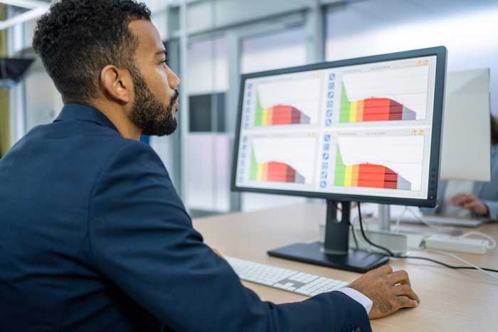 A business owner reviews data on a computer.