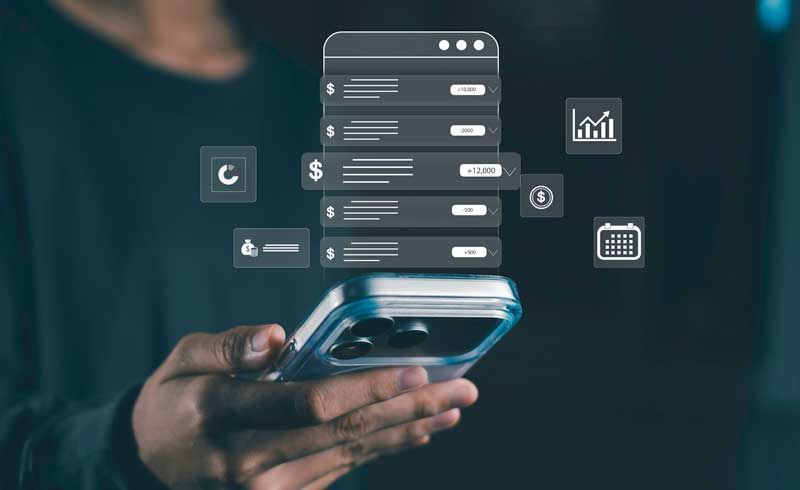 A person holds their cell phone as it appears to cast images surrounding finances and data records on spending.